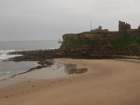 Beach and rocky headland under a grey sky