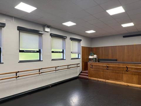 Dance studio with barres and a black floor