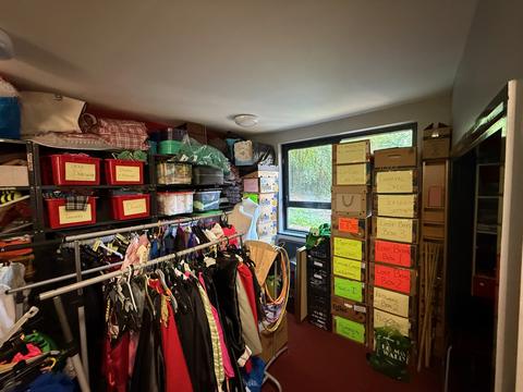 Costume store with rails and labelled boxes