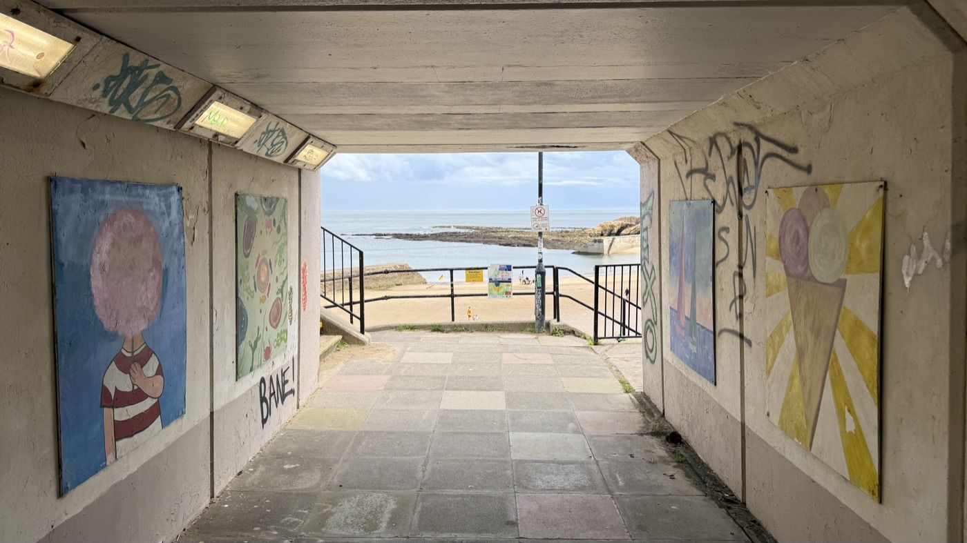 Painted seafront underpass at Cullercoats leading down to the beach.